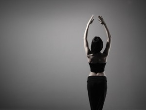 Young and sexy modern dancer over grey background